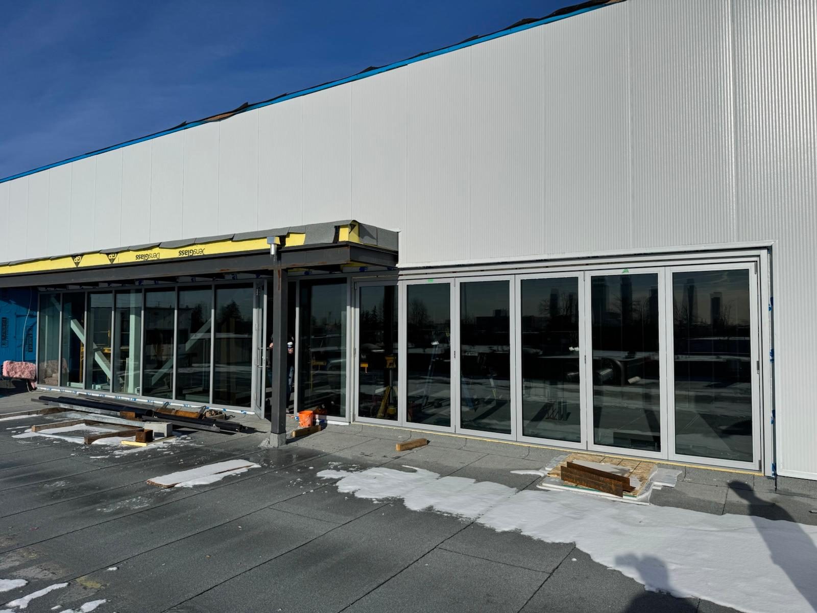 Row of new bi-fold glass doors on a commercial building