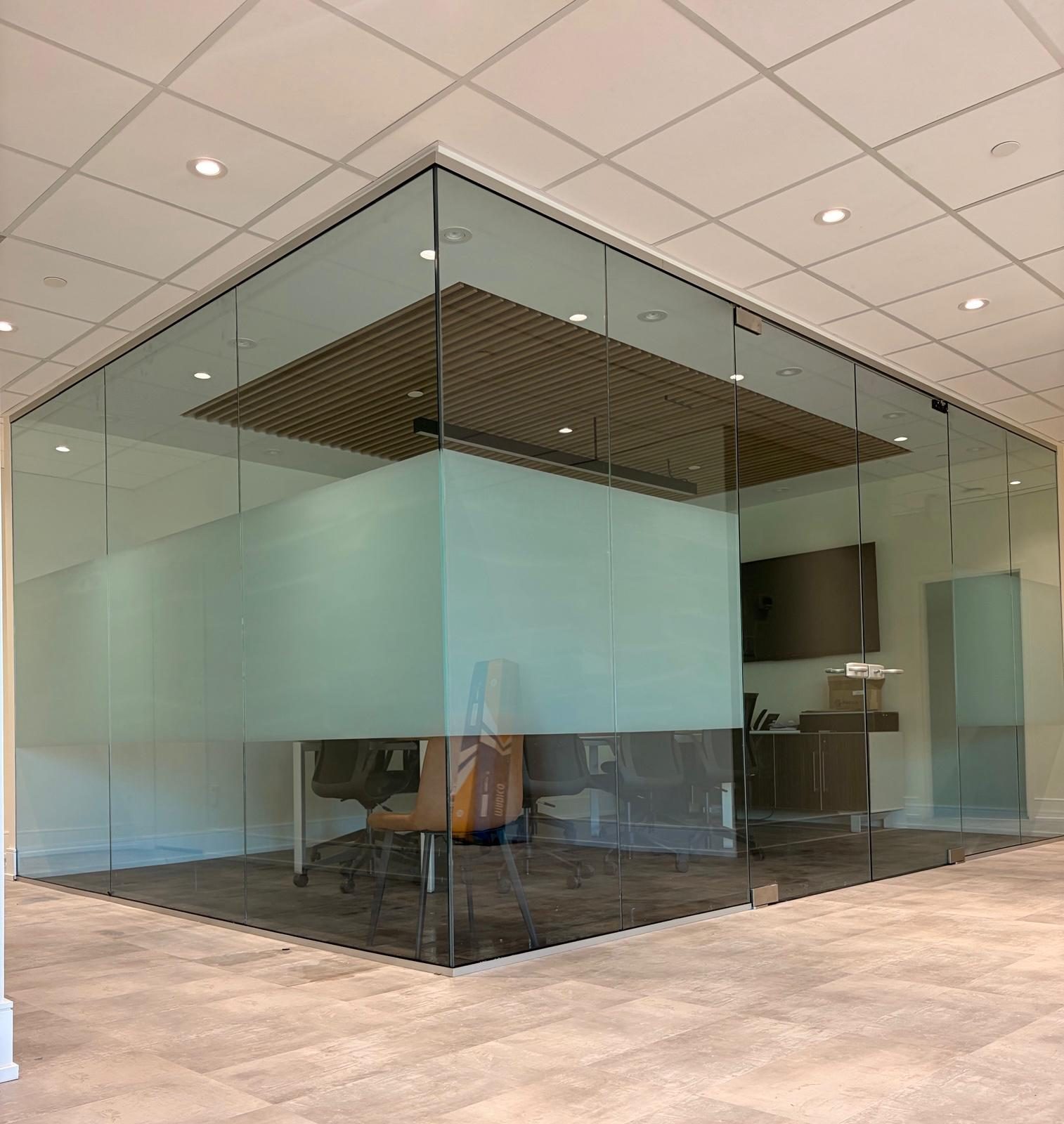 Glass-walled boardroom with a frosted privacy band