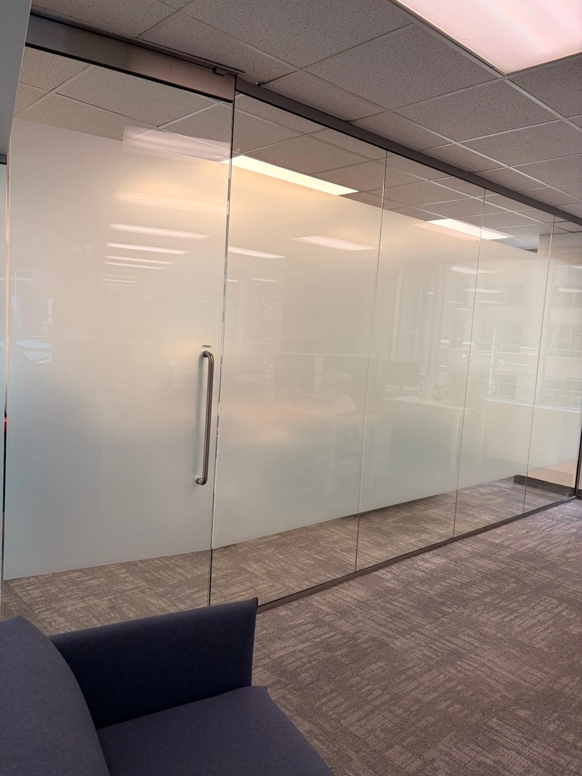 Office glass partition with a frosted privacy band