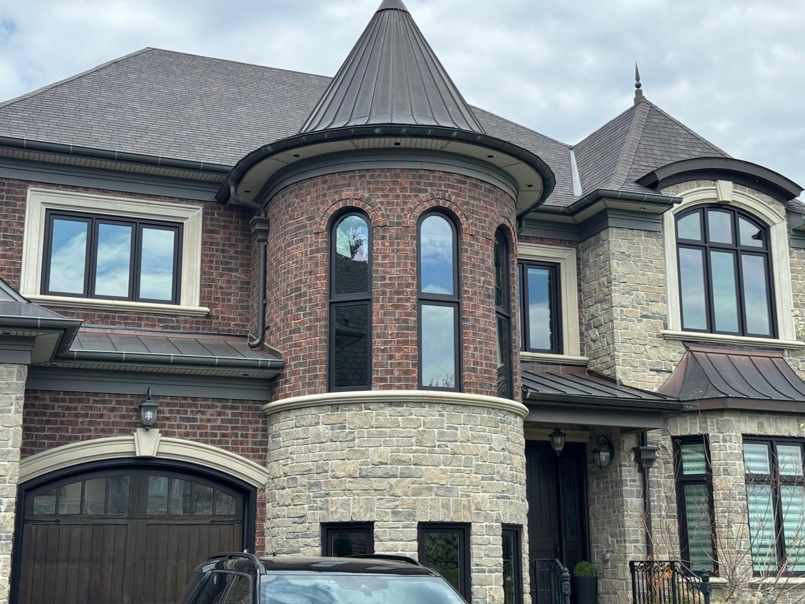 Brick and stone home with tinted security film on all front windows