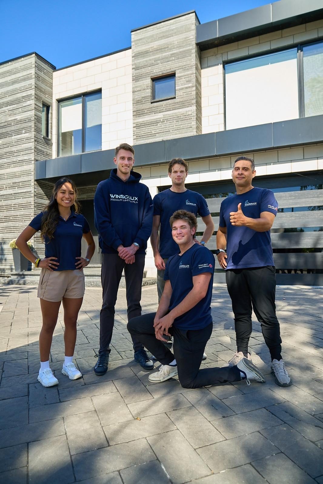 The Winsolux team in branded shirts in front of a finished residential install