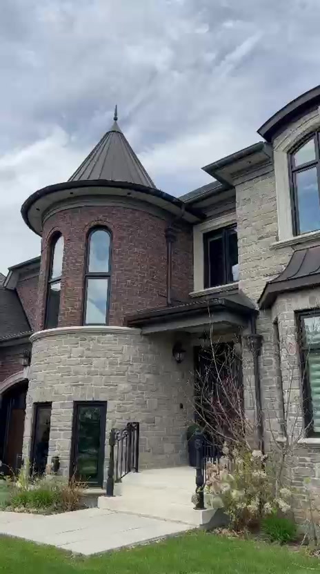 Stone and brick home exterior with film installed on all front windows